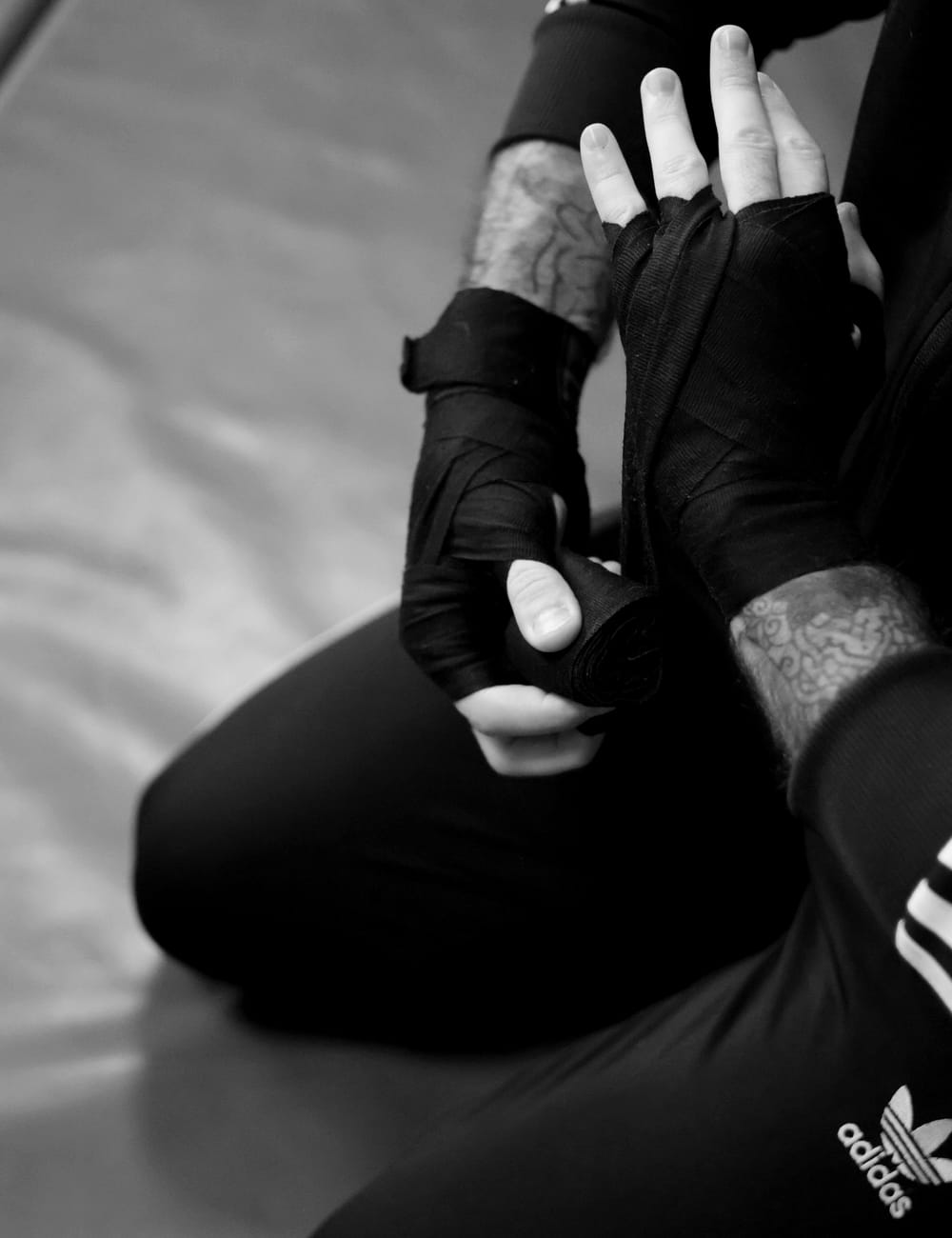 A fighter taping his hands before training