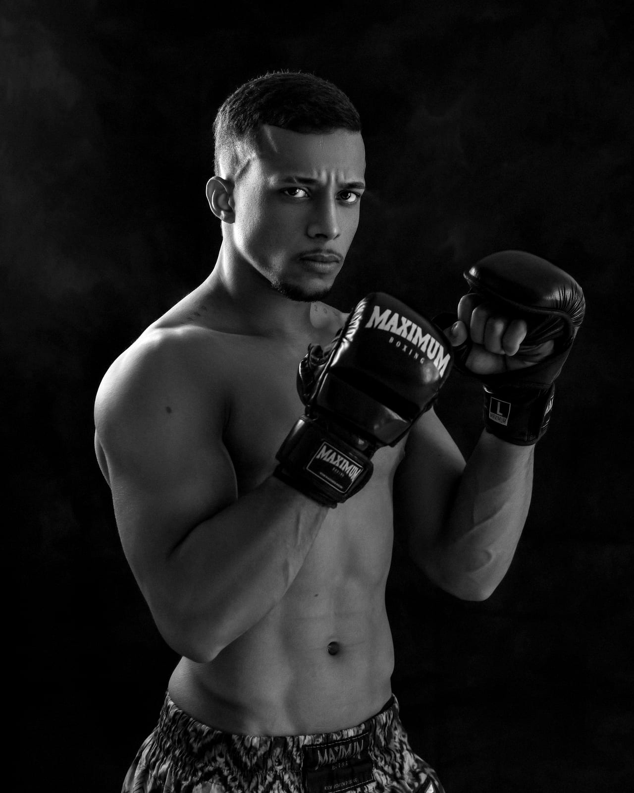 A fighter in MMA gloves looking into the camera